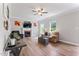 Bright living room with fireplace, ceiling fan, wood floors, neutral colors, and ample natural light at 347 Manchester Trl, Clayton, NC 27527