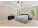 This large bedroom features two windows and a comfortable bed for a relaxing retreat at 347 Manchester Trl, Clayton, NC 27527
