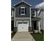 Charming two-story home featuring a white garage door, stone accents, and gray siding at 36 Twin Birch Dr, Angier, NC 27501