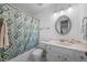 Bright bathroom features patterned shower curtain, vanity with sink, toilet, and a mirror with a white frame at 4 Barkridge Ct, Durham, NC 27713