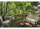 Charming outdoor deck with seating, surrounded by lush greenery for ultimate relaxation at 4 Barkridge Ct, Durham, NC 27713