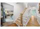 Inviting entryway featuring hardwood floors, staircase with wooden handrail and white risers at 4 Barkridge Ct, Durham, NC 27713