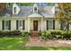 Beautiful home exterior with manicured landscaping, brick walkway, and welcoming entrance at 4 Barkridge Ct, Durham, NC 27713