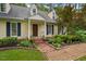 Inviting home exterior featuring a well-maintained front yard, brick pathway, and charming details at 4 Barkridge Ct, Durham, NC 27713