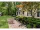 Charming home exterior featuring a brick pathway, beautiful landscaping, and curb appeal at 4 Barkridge Ct, Durham, NC 27713