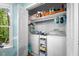 Bright laundry room featuring a washer, dryer, storage shelves, and a window with a view of the outdoors at 4 Barkridge Ct, Durham, NC 27713