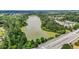 The aerial view shows the surrounding area with mature trees, local roads, and a nearby lake at 4003 Jockey Club Cir, Cary, NC 27519