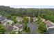 Aerial view of a tranquil neighborhood with lush trees and a quiet street with well-maintained homes at 4003 Jockey Club Cir, Cary, NC 27519