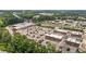Aerial view of commercial building and shopping center with a full parking lot and nearby landscaping at 4003 Jockey Club Cir, Cary, NC 27519