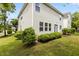 Well-maintained backyard with manicured shrubs and partial lawn at 4003 Jockey Club Cir, Cary, NC 27519