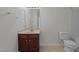 Bathroom with vanity, toilet, and a large mirror with overhead lighting at 4003 Jockey Club Cir, Cary, NC 27519