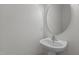 Bathroom featuring pedestal sink and a round mirror at 4003 Jockey Club Cir, Cary, NC 27519