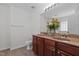 Bathroom featuring double sink vanity, tile floor, decorative mirror, and ample counter space at 4003 Jockey Club Cir, Cary, NC 27519