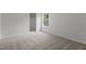 Bedroom showcasing neutral walls and carpet with large window and closet at 4003 Jockey Club Cir, Cary, NC 27519