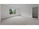 Spacious bedroom features a window with tree views and neutral carpet at 4003 Jockey Club Cir, Cary, NC 27519