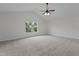 This bedroom features carpeting, a fan, and a window at 4003 Jockey Club Cir, Cary, NC 27519