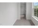 Bright bedroom featuring neutral carpet, walk-in closet, and a window that fills the space with natural light at 4003 Jockey Club Cir, Cary, NC 27519