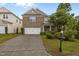 Beautiful brick home with a two-car garage, well-manicured lawn, and inviting curb appeal at 4003 Jockey Club Cir, Cary, NC 27519