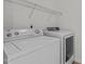 Bright laundry room with shelving, a washing machine and a dryer at 4003 Jockey Club Cir, Cary, NC 27519
