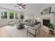 A bright living room with natural light, comfortable seating, and a decorative fireplace at 4003 Jockey Club Cir, Cary, NC 27519