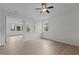 Open-concept living room with light wood floors and plenty of natural light at 4003 Jockey Club Cir, Cary, NC 27519