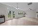 Bright living room featuring decorative doors and a chandelier at 4003 Jockey Club Cir, Cary, NC 27519