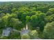 Aerial view of home on a corner lot, surrounded by mature trees in a residential neighborhood at 4012 Castle Ct, Raleigh, NC 27613