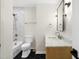 Full bathroom featuring black floors, marble countertop, and white tiled shower at 4012 Castle Ct, Raleigh, NC 27613