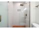 Modern bathroom with glass shower, rainfall shower head, and red tiled floor at 4012 Castle Ct, Raleigh, NC 27613
