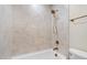 Full bathroom with bronze hardware, shower-tub combo, and cream-colored tiles at 4012 Castle Ct, Raleigh, NC 27613