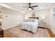 Cozy bedroom with neutral tones, ceiling fan, and large windows for natural light at 4012 Castle Ct, Raleigh, NC 27613
