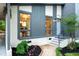 Charming front exterior with a light blue door, manicured landscaping, and large window views at 4012 Castle Ct, Raleigh, NC 27613