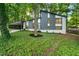 Striking home exterior featuring a modern design, lush landscaping, and mature trees, offering a serene and inviting setting at 4012 Castle Ct, Raleigh, NC 27613