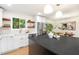 Well-lit kitchen with white cabinets, stainless steel appliances, and wooden shelves, providing a functional and stylish cooking space at 4012 Castle Ct, Raleigh, NC 27613