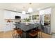 Modern kitchen with white cabinetry, stainless steel appliances, a large island, and stylish decor at 4012 Castle Ct, Raleigh, NC 27613