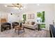 Bright living room with hardwood floors, modern lighting, and large windows at 4012 Castle Ct, Raleigh, NC 27613