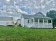 Back of home showing porch, deck, siding, and landscaping at 4016 Berman Edge Rd, Holly Springs, NC 27540