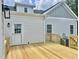 Back of home with new wooden deck, back door, and light gray siding at 4016 Berman Edge Rd, Holly Springs, NC 27540