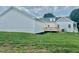 Back of home with new wooden deck, light gray siding, and lawn at 4016 Berman Edge Rd, Holly Springs, NC 27540