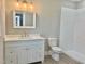 Bathroom featuring modern white cabinets, vanity, toilet and tiled shower at 4016 Berman Edge Rd, Holly Springs, NC 27540