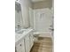 Bathroom with a tub and shower, marble-look countertop vanity, and vinyl floor at 4016 Berman Edge Rd, Holly Springs, NC 27540