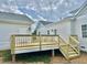 Back wooden deck and stairs with light gray siding on home and guest home at 4016 Berman Edge Rd, Holly Springs, NC 27540