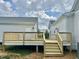 Wooden deck and stairs with light gray siding on home and guest home at 4016 Berman Edge Rd, Holly Springs, NC 27540