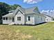 Side view of home showcasing the exterior with professional landscaping and a manicured lawn at 4016 Berman Edge Rd, Holly Springs, NC 27540