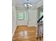 Foyer featuring hardwood floors, chandelier and neutral paint at 4016 Berman Edge Rd, Holly Springs, NC 27540