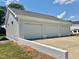 Detached three car garage with concrete driveway and parking pad with brick retaining wall at 4016 Berman Edge Rd, Holly Springs, NC 27540
