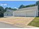 Large three-car garage and driveway with adjacent home at 4016 Berman Edge Rd, Holly Springs, NC 27540