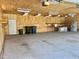 Spacious three car garage featuring plywood walls, concrete floors, and ample lighting at 4016 Berman Edge Rd, Holly Springs, NC 27540