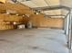Interior of three-car garage with refrigerator, workspace, and concrete floor at 4016 Berman Edge Rd, Holly Springs, NC 27540
