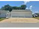 Detached three car garage with concrete driveway and parking pad at 4016 Berman Edge Rd, Holly Springs, NC 27540